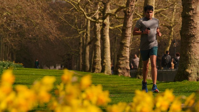 A man jogs in St James's Park, central London. Pic: PA 