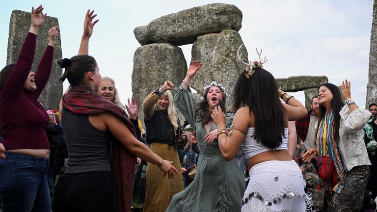 Women dance as they attend spring equinox celebrations at Stonehenge stone.  Pic: Reuters