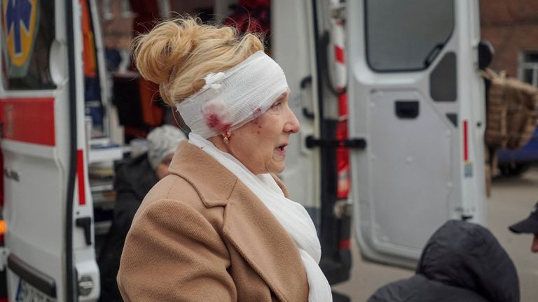 SENSITIVE MATERIAL. THIS IMAGE MAY OFFEND OR DISTURB A wounded person stands near an apartment building damaged during a Russian missile strike, amid Russia's attack on Ukraine, in Sumy, Ukraine March 24, 2025. REUTERS/Stringer

