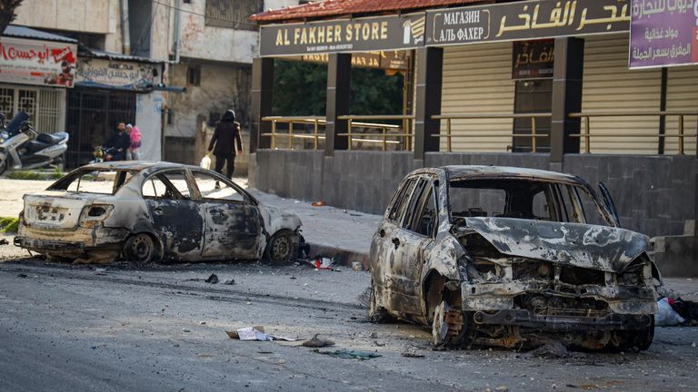 Burnt cars remain in the middle of a street following the recent wave of violence between Syrian security forces and gunmen loyal to former President Bashar Assad, as well as subsequent sectarian attacks, in the town of Jableh, Syria's coastal region, Monday, March 10, 2025. (AP Photo/Omar Albam)