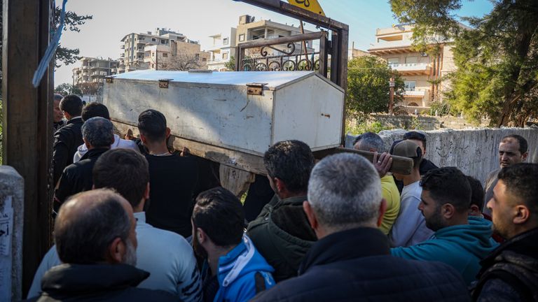 The coffin carrying the body of Nawaf Khalil Baytar, who was killed during the recent wave of violence between Syrian security forces and gunmen loyal to former President Bashar Assad, is carried for burial in Jableh, Syria's coastal region, Monday, March 10, 2025. (AP Photo/Omar Albam)