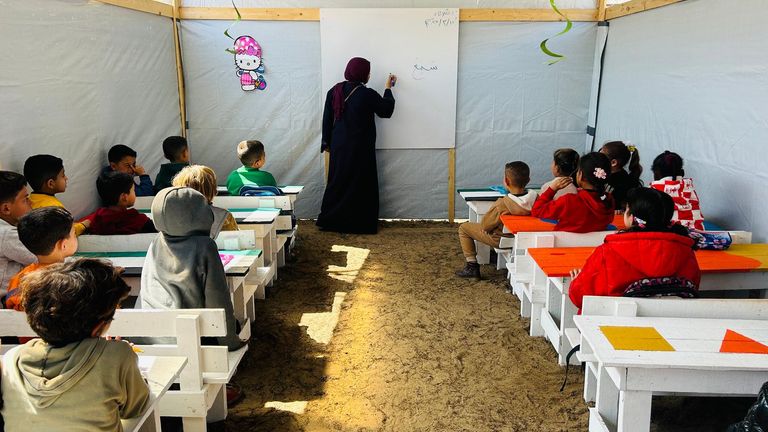 Children being taught in one of the tent schools