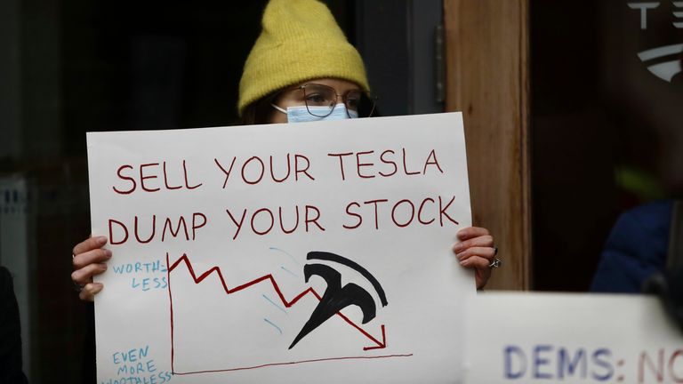 A protester outside a Tesla showroom in Seattle in February. Pic: AP
