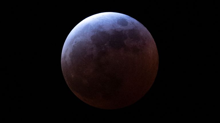 A total lunar eclipse enters its peak stage Thursday, March 13, 2025, in Portland, Ore. (AP Photo/Jenny Kane)