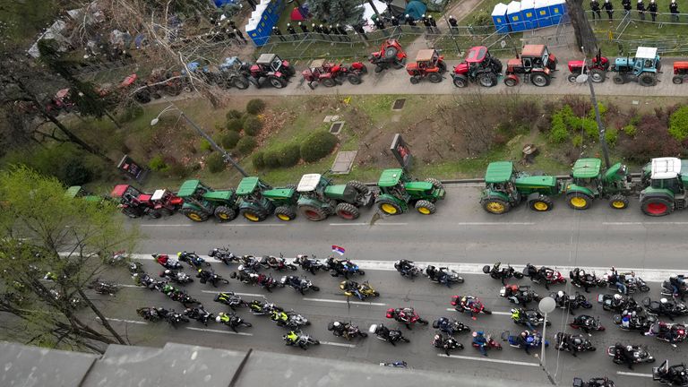 Supporters of the president have camped inside a ring of parked tractors. Pic: AP 