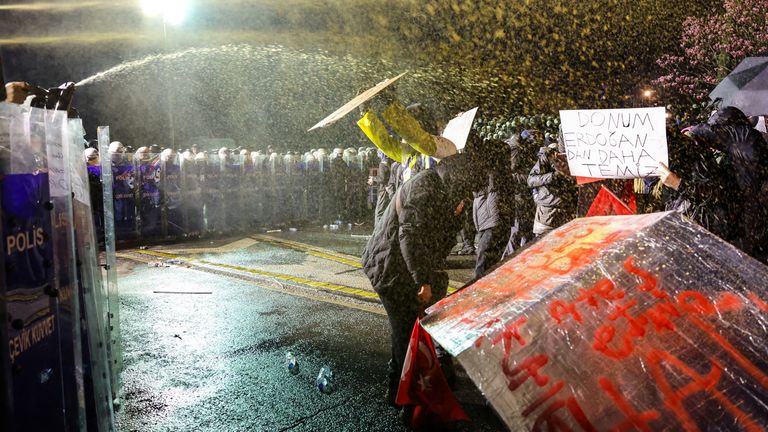 A protester holds a placard that reads ''My underwear is cleaner than Erdogan'', as police officers use pepper spray on demonstrators during a protest on the day Istanbul Mayor Ekrem Imamoglu was jailed as part of a corruption investigation, in Istanbul, Turkey, March 23, 2025. REUTERS/Murad Sezer