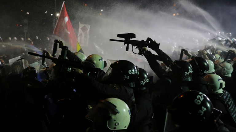 Riot police officers use anti riot rifles and pepper spray to clear protesters during a protest after Istanbul's Mayor Ekrem Imamoglu was arrested and sent to prison, in Istanbul, Turkey, Sunday, March 23, 2025. (AP Photo/Huseyin Aldemir)