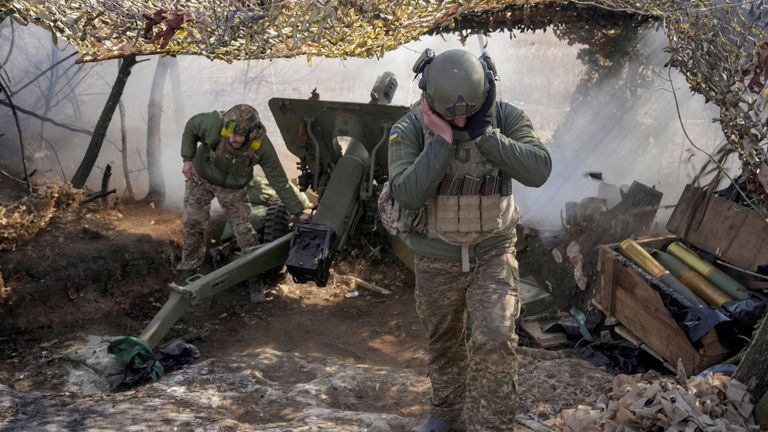 Ukrainian servicemen fire a howitzer on the frontline. Pic: Reuters