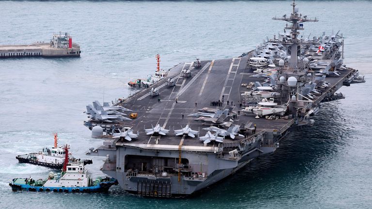 The USS Carl Vinson aircraft carrier is escorted into the port of Busan in South Korea on Sunday. Pic: Son Hyung-ju/Yonhap via AP