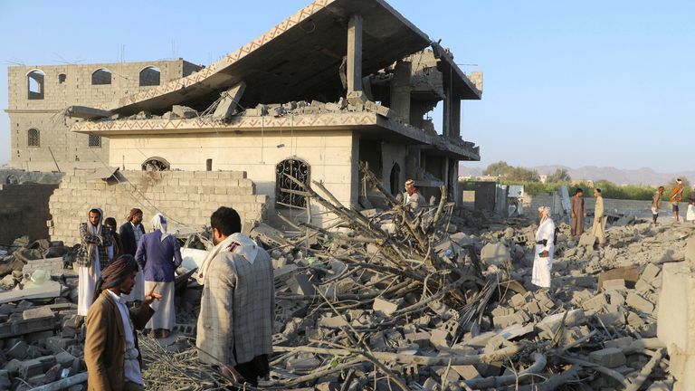 People stand on the rubble of a house hit by a U.S. strike in Saada, Yemen March 16, 2025. REUTERS/Naif Rahma