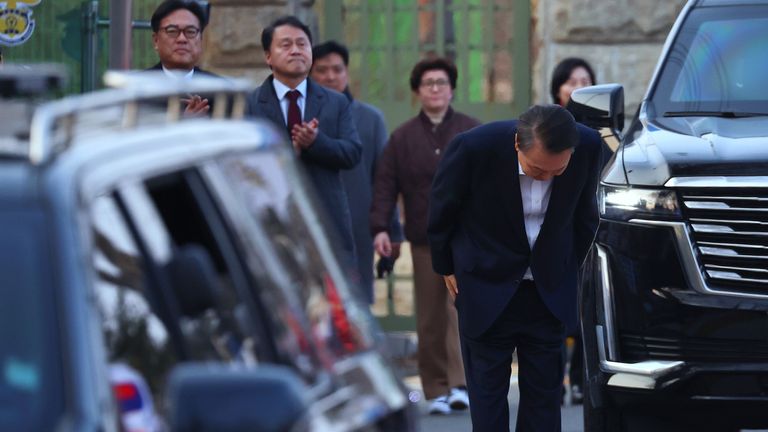 Yoon Suk Yeol greets his supporters as he comes out of a detention centre. Pic: AP