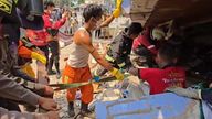 Rescue workers searching through destroyed buildings