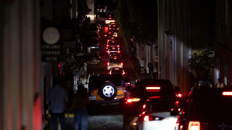 Cars drive through a dark street after Puerto Rico was hit with a massive power outage. Pic: Reuters