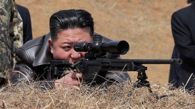 Kim Jong Un fires a sniper rifle. Pic: Reuters