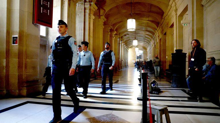French gendarmes walk inside the courthouse on the first day of the trial of 10 people accused of stealing millions of dollars worth of jewellery from Kim Kardashian, who was held at gunpoint in her apartment during Paris fashion week in 2016, a trial known as the "Rue Tronchet" affair, at the Court of Appeal of Paris, France, April 28, 2025. REUTERS/Sarah Meyssonnier