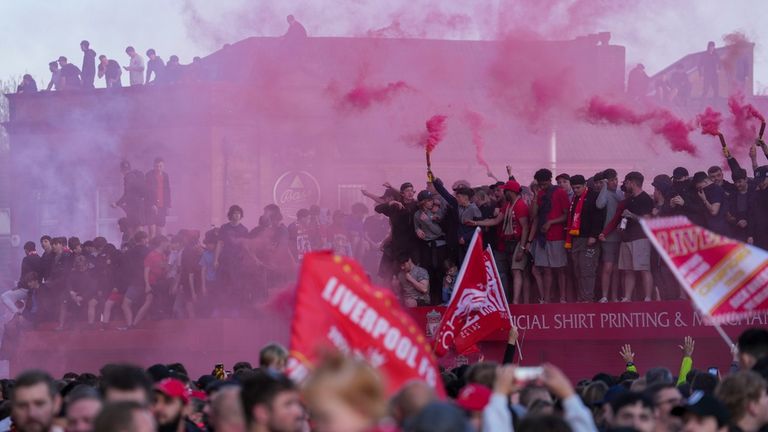 Fans set off red flares to celebrate the historic win outside Anfield. Pic: AP