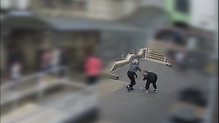 The 14-year-old girl wrestling with teacher Liz Hopkin in the school playground.
Pic:Dyfed-Powys Police/PA