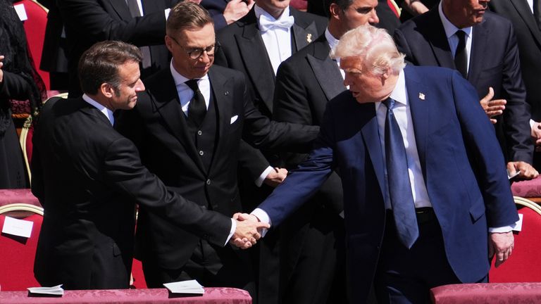 President Donald Trump, right, shakes hands with French President Emmanuel Macron, left, as Finland's President Alexander Stubb, looks on, as they attend the funeral of Pope Francis in St. Peter's Square at the Vatican, Saturday, April 26, 2025. (AP Photo/Evan Vucci)