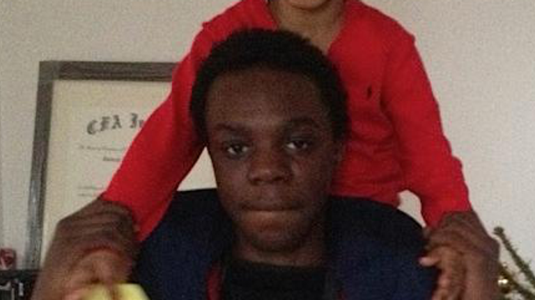 Ola Raji pictured with a child on his shoulders. Pic: Met Police