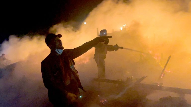Palestinians try to extinguish the flames after an Israeli airstrike on tents sheltering displaced people, in Khan Younis, in the southern Gaza Strip.
Pic: Reuters