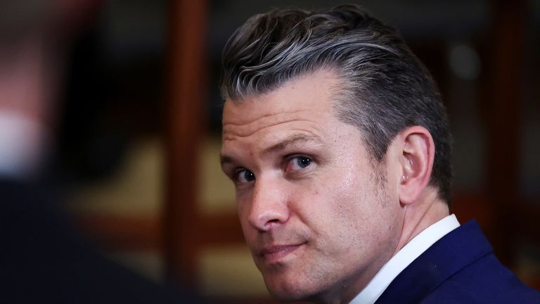 U.S. Defense Secretary Pete Hegseth waits for a presentation of the Commander-in-Chief trophy to the U.S. Navy Midshipmen football team of the United States Naval Academy by U.S. President Donald Trump, at the White House in Washington, D.C., U.S., April 15, 2025. REUTERS/Evelyn Hockstein