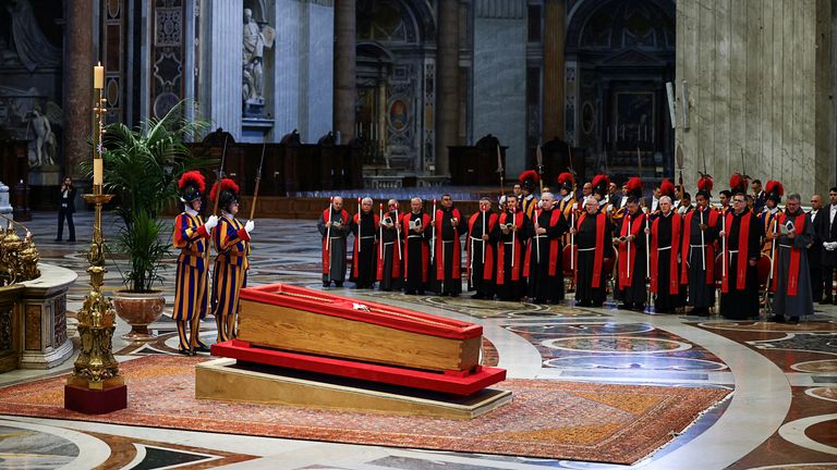 Members of the Swiss Guard stand next to the coffin containing Pope Francis's body. Pic: Reuters