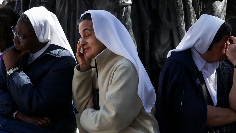 A nun reacts as faithful attend the funeral Mass of Pope Francis in St. Peter's Square, at the Vatican, April 26, 2025. REUTERS/Kevin Coombs
