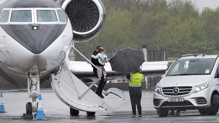 McIlroy carries his daughter Poppy off the plane. Pic: Kevin Scott/Belfast Telegraph