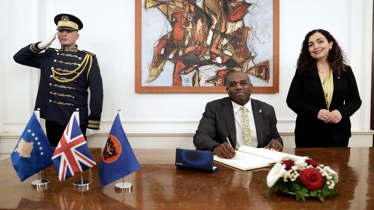 Foreign Secretary David Lammy signs a friendship book with President of Kosovo Vjosa Osmani during his visit to Kosovo and Serbia. 
Pic: PA