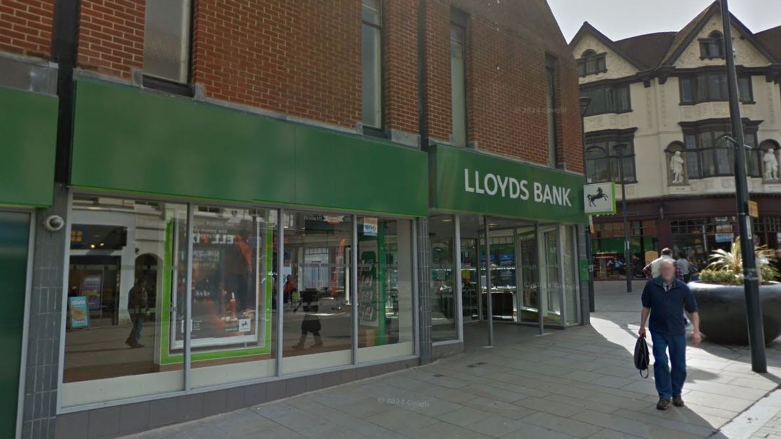 Customer stabbed to death inside Lloyds bank in Derby - as two men arrested