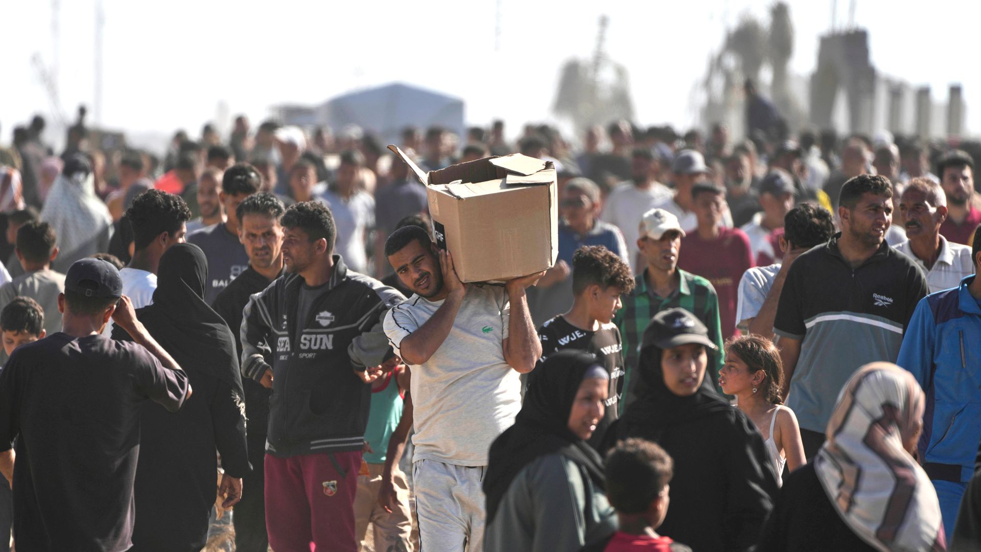 One dead and dozens injured after gunfire at aid hub in Gaza