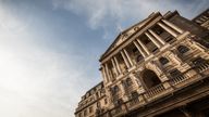 Low, wide angle view of the facade to the Bank of England in the City of London set against blue sky copy space.