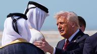 President Donald Trump is greeted by Qatar's Emir Sheikh Tamim bin Hamad Al Thani as he arrives on Air Force One at Hamad International Airport in Doha, Qatar, Wednesday, May 14, 2025. (AP Photo/Alex Brandon)