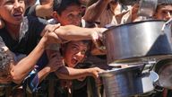 Palestinians struggle to receive cooked food distributed at a community kitchen in the Muwasi area of Khan Younis, in the Gaza Strip, on Friday 23 May 2025. Pic: AP