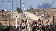 Israeli army tanks are seen positioned as smoke rises in the background in southern Gaza, as seen from a humanitarian aid distribution center operated by the U.S.-backed Gaza Humanitarian Foundation, approved by Israel, in Khan Younis, southern Gaza Strip, on Thursday, May 29, 2025. (AP Photo/Abdel Kareem Hana)