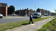 Officers and a police vehicle at the scene of the stabbing