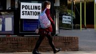 A student walks past a polling station in Rickmansworth, Britain, May 1, 2025. REUTERS/Suzanne Plunkett
