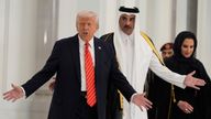 Donald Trump and Qatar's Emir Sheikh Tamim bin Hamad Al Thani gesture as they participate in a state dinner at the Lusail Palace, in Doha, Qatar. Pic: AP