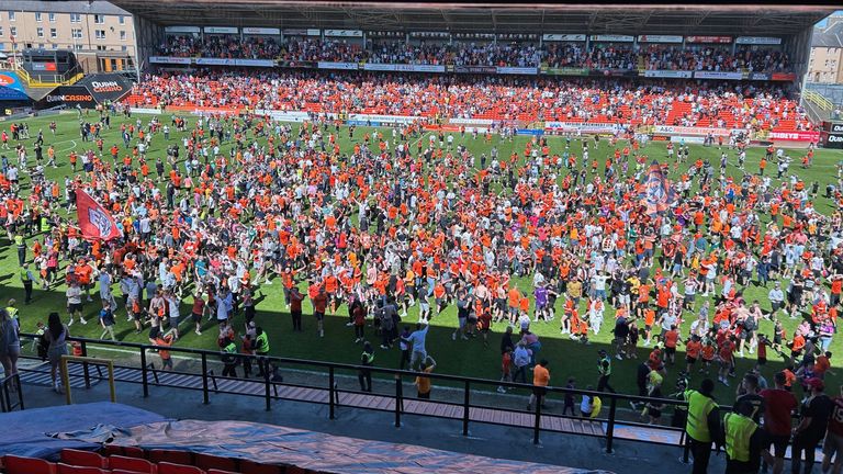 Fans invade the pitch after Dundee United's victory over Aberdeen at Tannadice Park, Dundee. Picture date: Saturday May 17, 2025. Pic: PA 