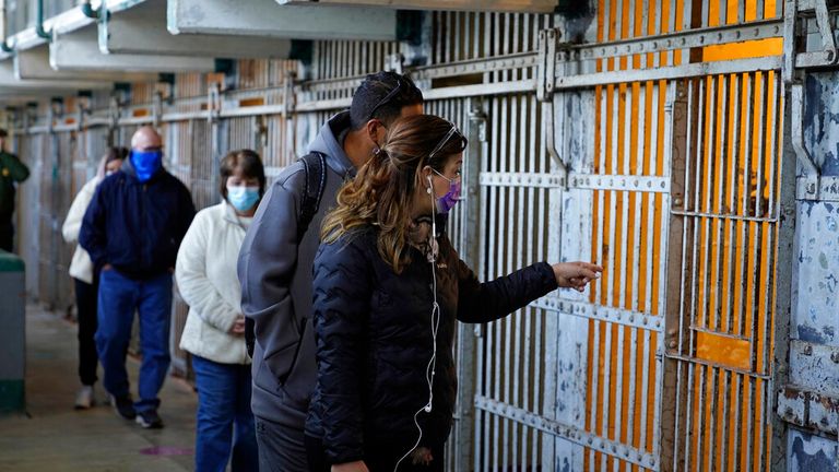 People tour the main cell house on Alcatraz Island in San Francisco, Monday, March 15, 2021. The historic island prison was reopened to visitors Monday after being closed since December because of the coronavirus threat. Visitors were also able to tour the inside of the main cell house for the first time in a year. (AP Photo/Eric Risberg)