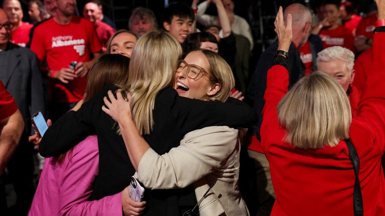 Supports of Anthony Albanese hugged at a Labor Party election night event after ABC called the result. Pic: Reuters