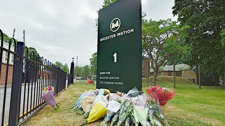 Floral tributes left near the scene of a fire at Bicester Motion in Oxfordshire, where two firefighters and a member of the public have died, and two firefighters were also seriously injured. A large fire broke out on Thursday at the site of a former RAF base, which is home to more than 50 specialist businesses focused on classic car restoration and engineering. Picture date: Saturday May 17, 2025.