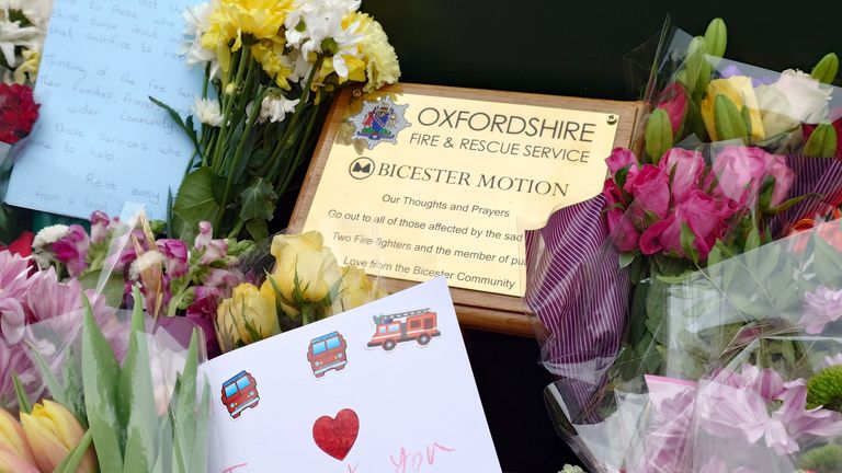 Floral tributes left near the scene of a fire at Bicester Motion in Oxfordshire, where two firefighters and a member of the public have died, and two firefighters were also seriously injured. A large fire broke out on Thursday at the site of a former RAF base, which is home to more than 50 specialist businesses focused on classic car restoration and engineering. Picture date: Saturday May 17, 2025. PA Photo. See PA story FIRE Bicester. Photo credit should read: Jamie Lashmar/PA Wire