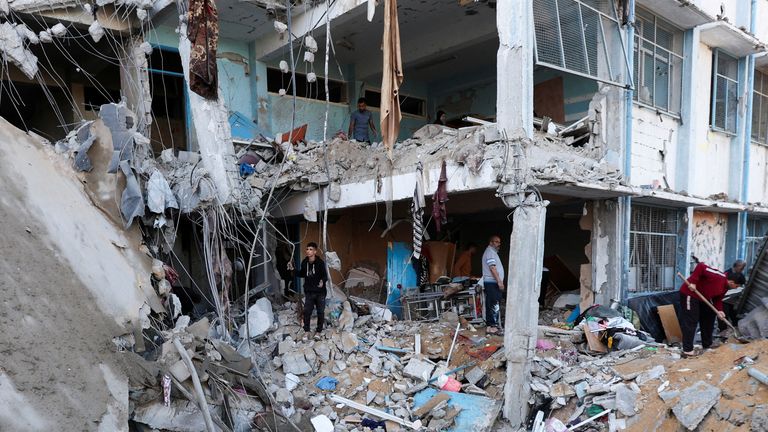 Palestinians inspect the site of an Israeli strike on an UNRWA school sheltering displaced people, in the Bureij camp in the central Gaza Strip, May 7, 2025. REUTERS/Ramadan Abed TPX IMAGES OF THE DAY