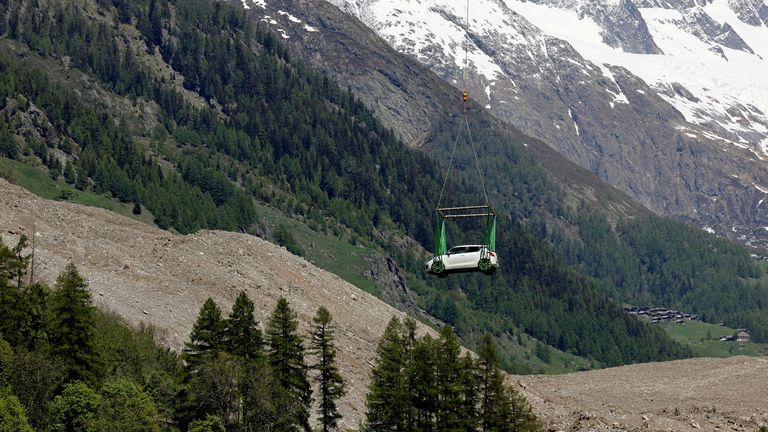 A car is carried by helicopter near Blatten, Switzerland May 29, 2025. REUTERS/Stefan Wermuth    