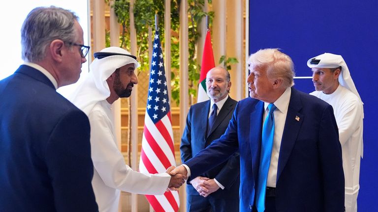 President Donald Trump is greeted by a participant as he attends a business meeting at Qasr Al Watan, Friday, May 16, 2025, in Abu Dhabi, United Arab Emirates. (AP Photo/Alex Brandon)