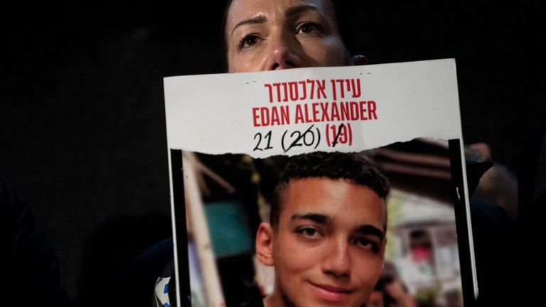 FILE - Yael Alexander holds a poster of her son, Edan, who was taken hostage by Hamas militants on Oct. 7, 2023, during a weekly rally for families of hostages held in the Gaza Strip and their supporters, in Tel Aviv, Israel, Feb. 22, 2025. (AP Photo/Maya Alleruzzo, File)