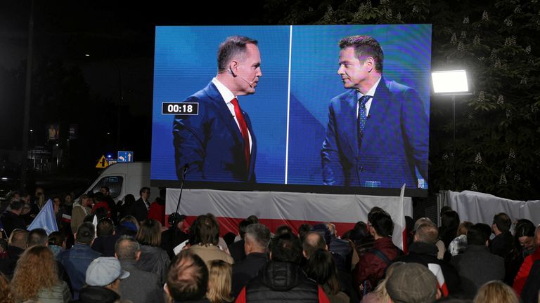 Karol Nawrocki, a candidate for Polish presidential election supported by Poland's main opposition party Law and Justice (PiS), and Civic Coalition presidential candidate, Warsaw mayor Rafal Trzaskowski, are seen on a screen during the presidential candidates' election debate, in front of the Polish Television headquarters in Warsaw, Poland, May 12, 2025. Kuba Atys/Agencja Wyborcza.pl via REUTERS ATTENTION EDITORS - THIS IMAGE WAS PROVIDED BY A THIRD PARTY. POLAND OUT. NO COMMERCIAL OR EDITORIAL