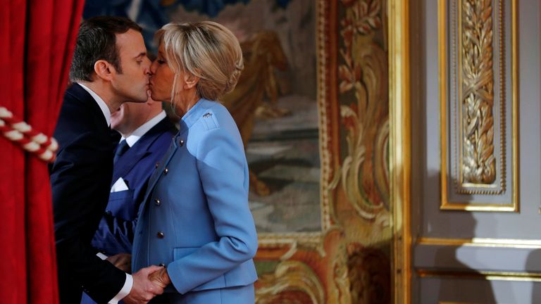  French President Emmanuel Macron kisses his wife Brigitte Trogneux during the handover ceremony in Paris, France, May 14, 2017. REUTERS/Philippe Wojazer
