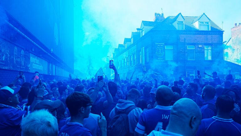Flares see the sky turn blue outside Goodison Park. Pic: PA